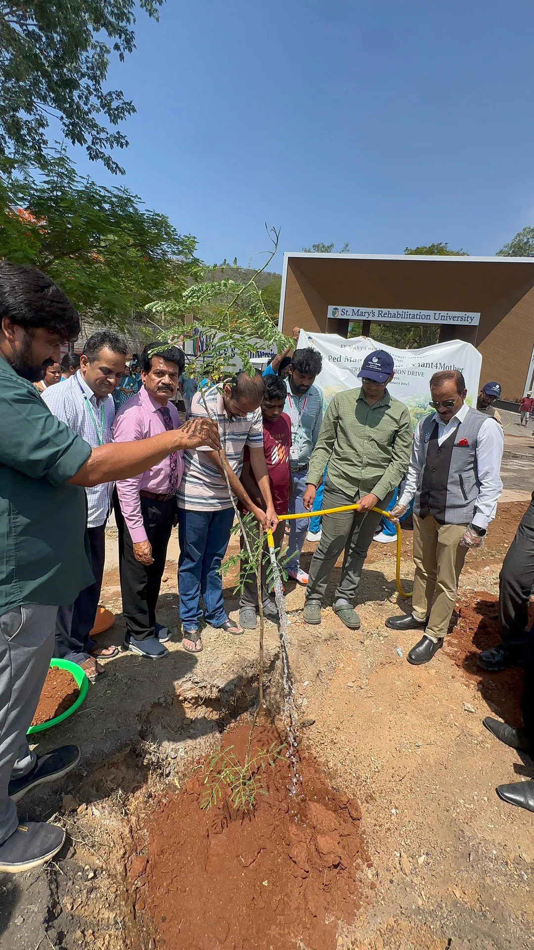 SMRU Tree Plantation Drive participants watering a newly planted tree